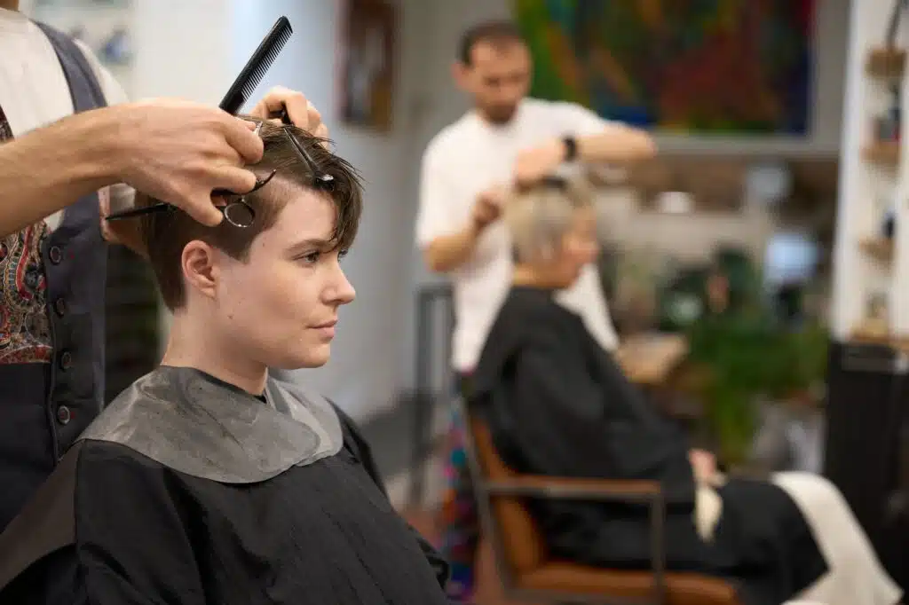Hairdresser cutting hair of young female model in salon Υπηρεσία κουρέματος FACE METRIC | Rena Loizou